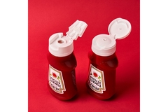 Two Heinz ketchup bottles next to eachother.